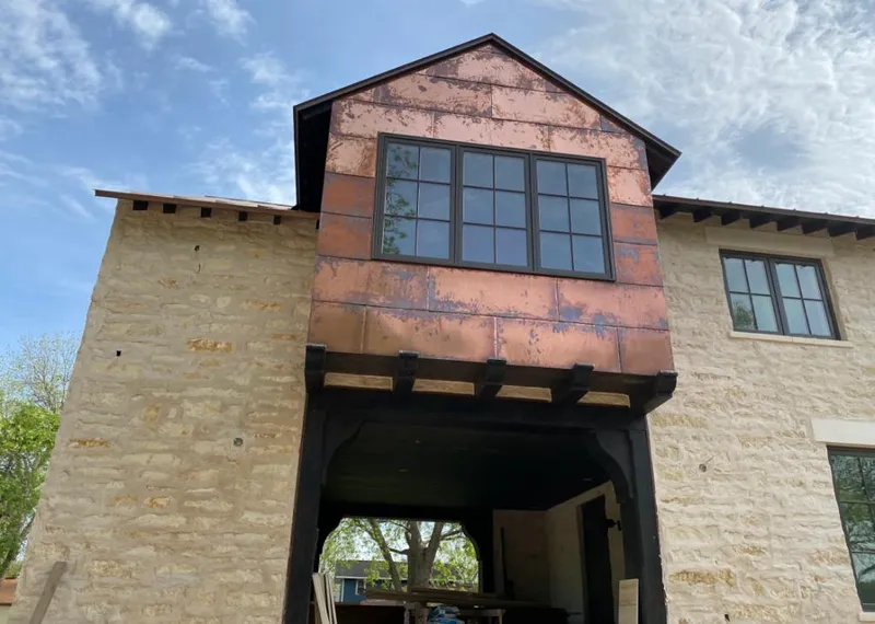 Copper metal panel facade on a stone building for Skylight Installation in Creve Coeur