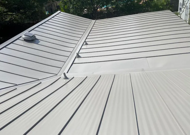 Solar attic fan installed on a metal roof for Roof Ventilation in Creve Coeur
